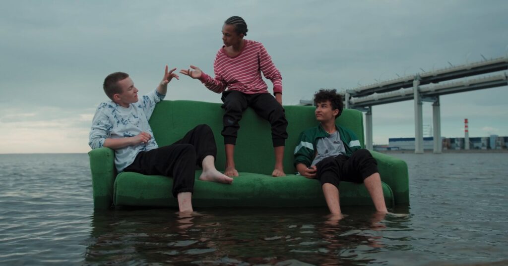 youngsters sitting on a couch in the sea